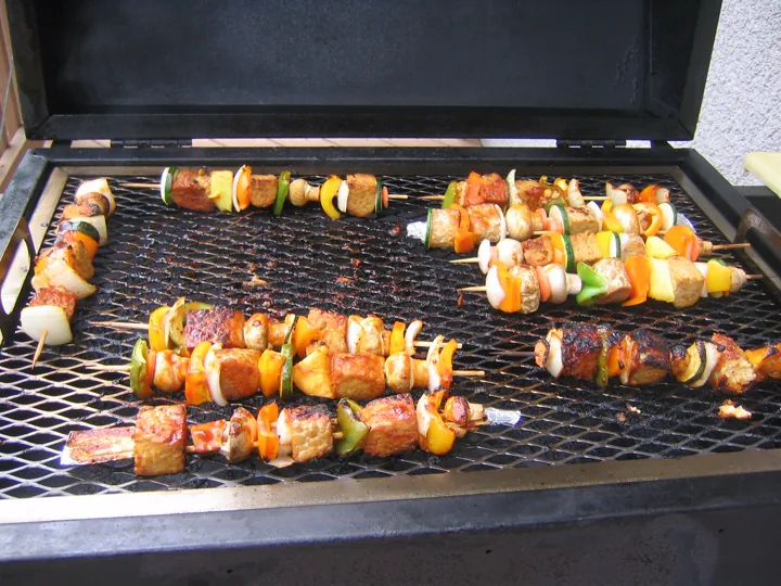 Skewers of grilled meat and peppers on a barbecue