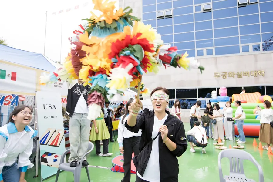 Visitors laughing together between the country booths on festival day