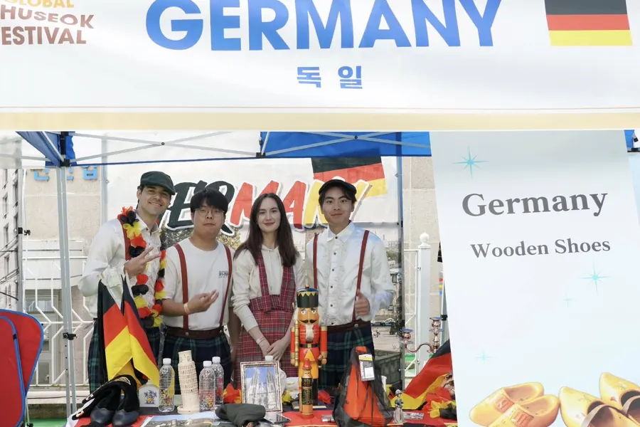 The Germany booth team standing behind their display table