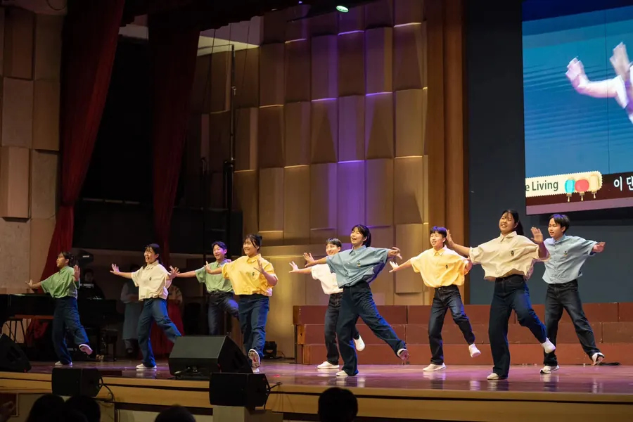 A team of dancers performing together on the main stage