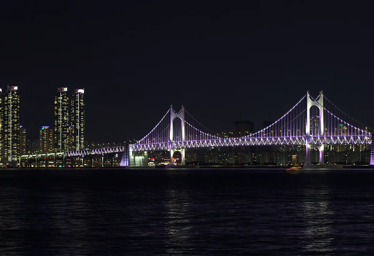 Gwangan Bridge lit up at night across the water
